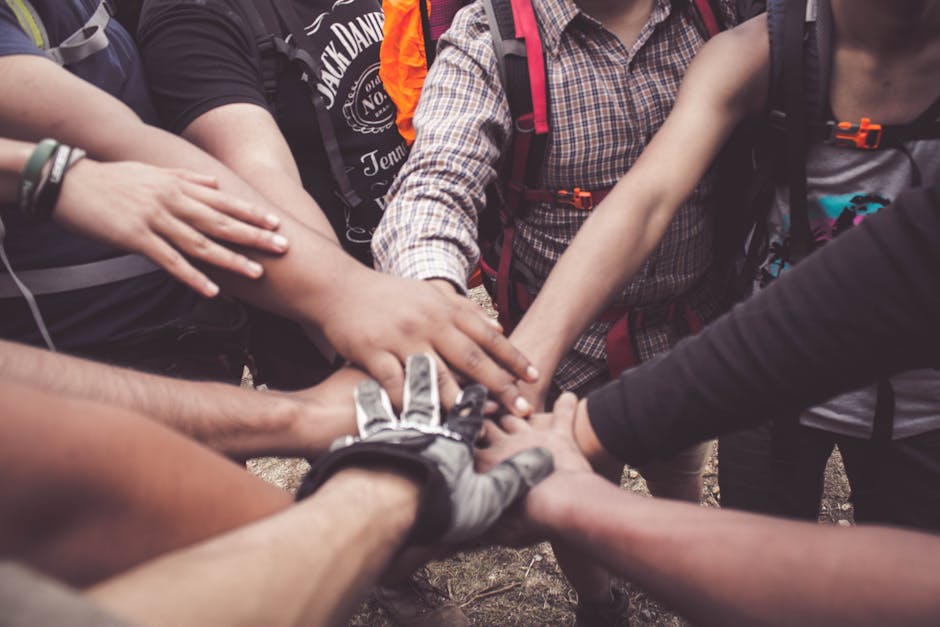 pexels-photo-3280130-3280130 A group of diverse individuals join hands for teamwork in West Java, Indonesia.